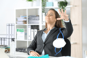 Woman dropping mask at work