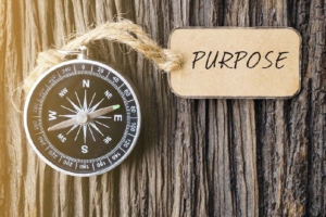Compass with attached tag that reads: Purpose