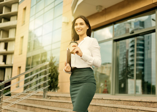 Young woman walking out of tech office