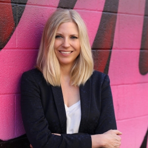 Kim Jones standing in front of a wall