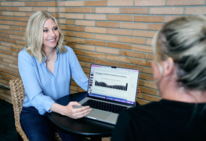 Kim Jones, Executive Career Coach, showing career statistics to female employee
