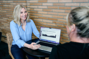 Kim Jones, Executive Career Coach, showing career statistics to female employee