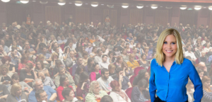 Kim Jones, executive career coach, standing in front of crowded audience at career conference