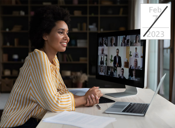 Woman setting in front of computer for virtual seminar