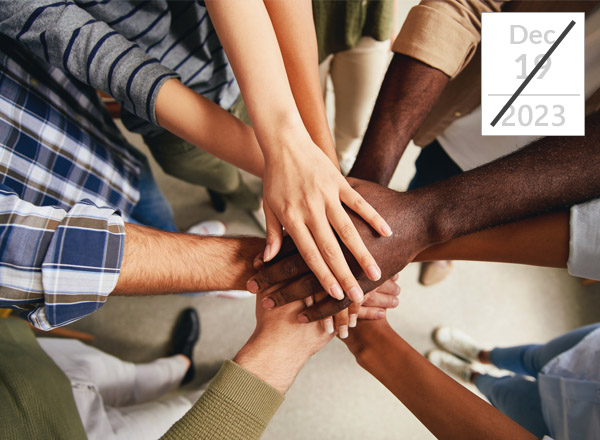 Employees putting hands together in unison